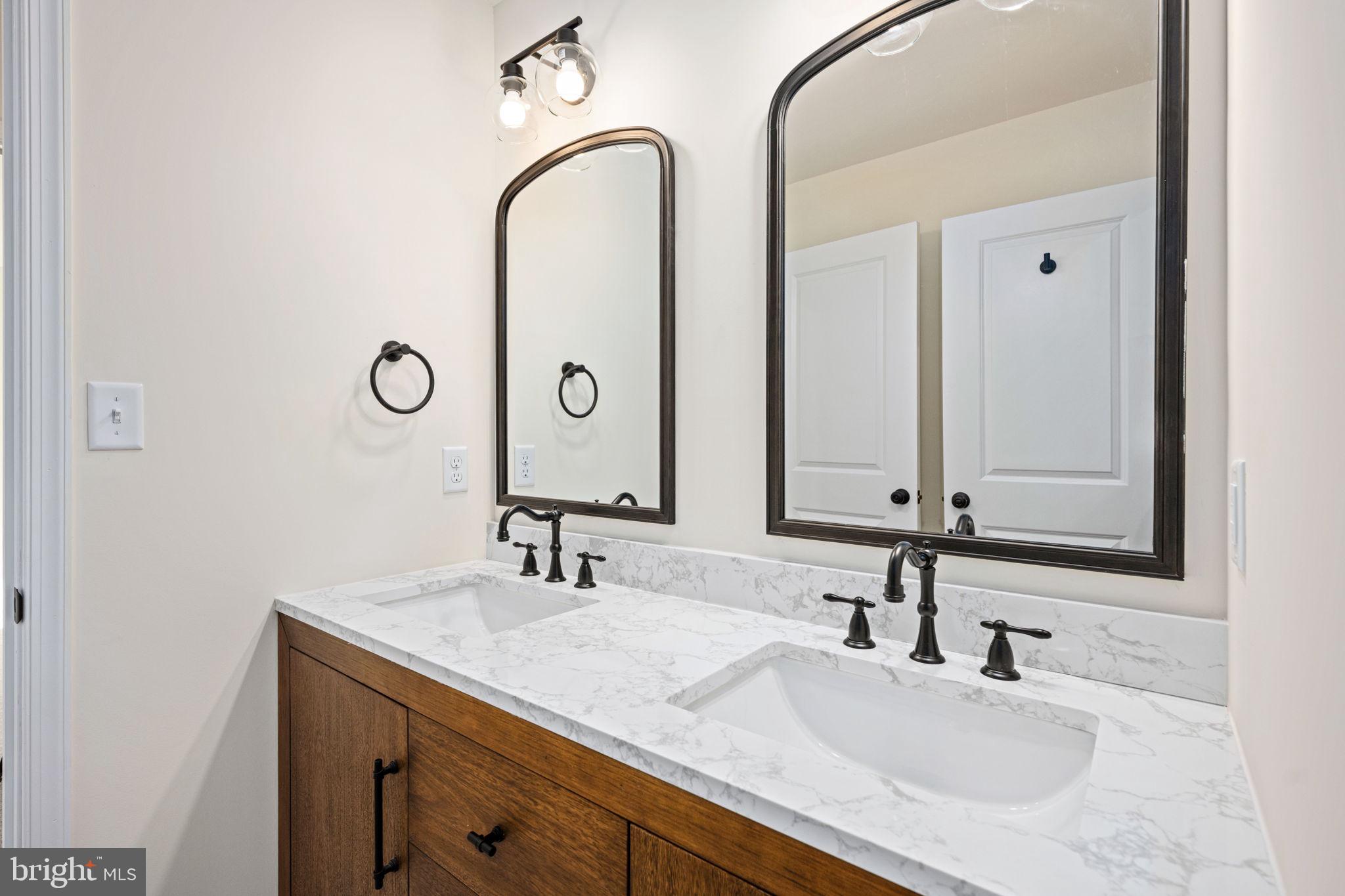 107 Saylers Creek Road Locust Grove, VA 22508 - Photo 46 of 78 a bathroom with a double vanity sink and a mirror