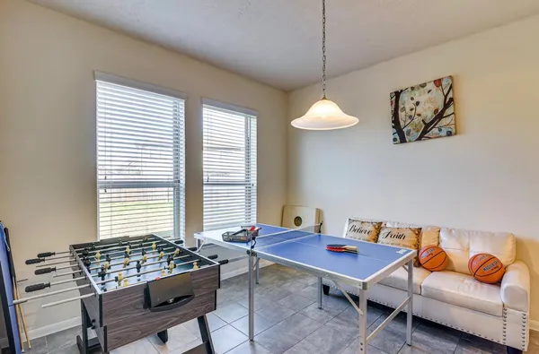 a living room with furniture a rug and a window