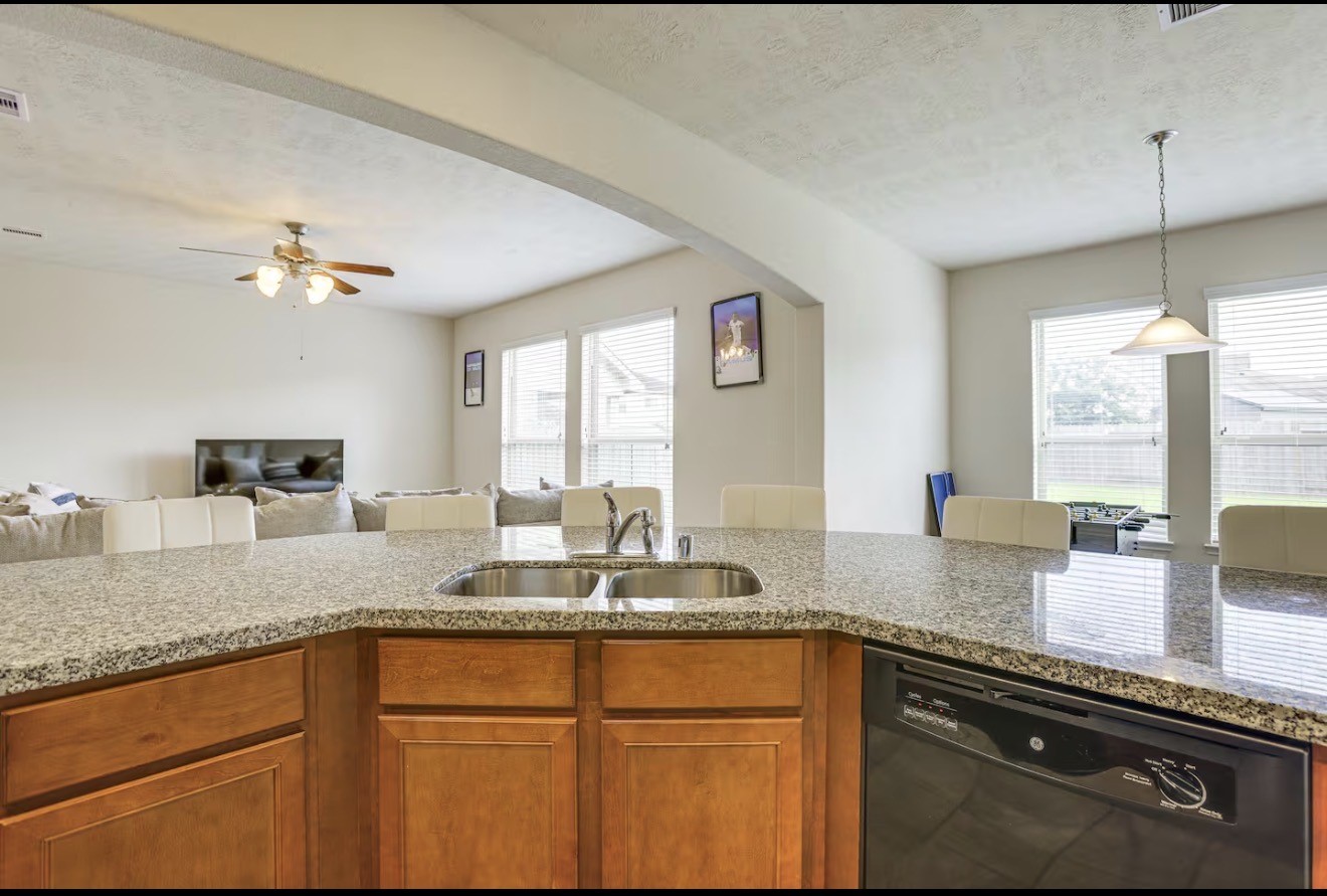 15015 Winter Valley Court Humble, TX 77396 - Photo 17 of 39 a kitchen with granite countertop a sink stainless steel appliances and a counter space