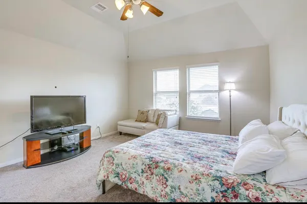 a bedroom with a bed and a flat screen tv