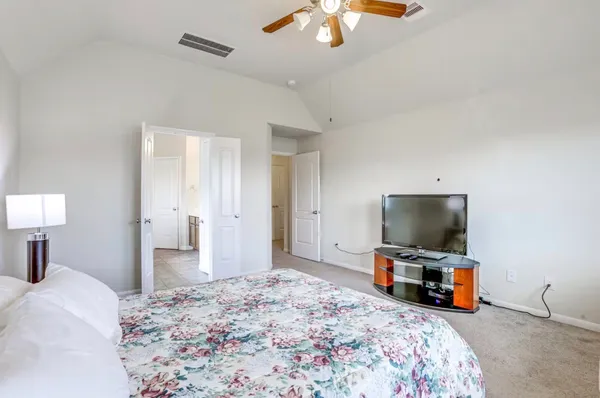 a bedroom with bed and tv