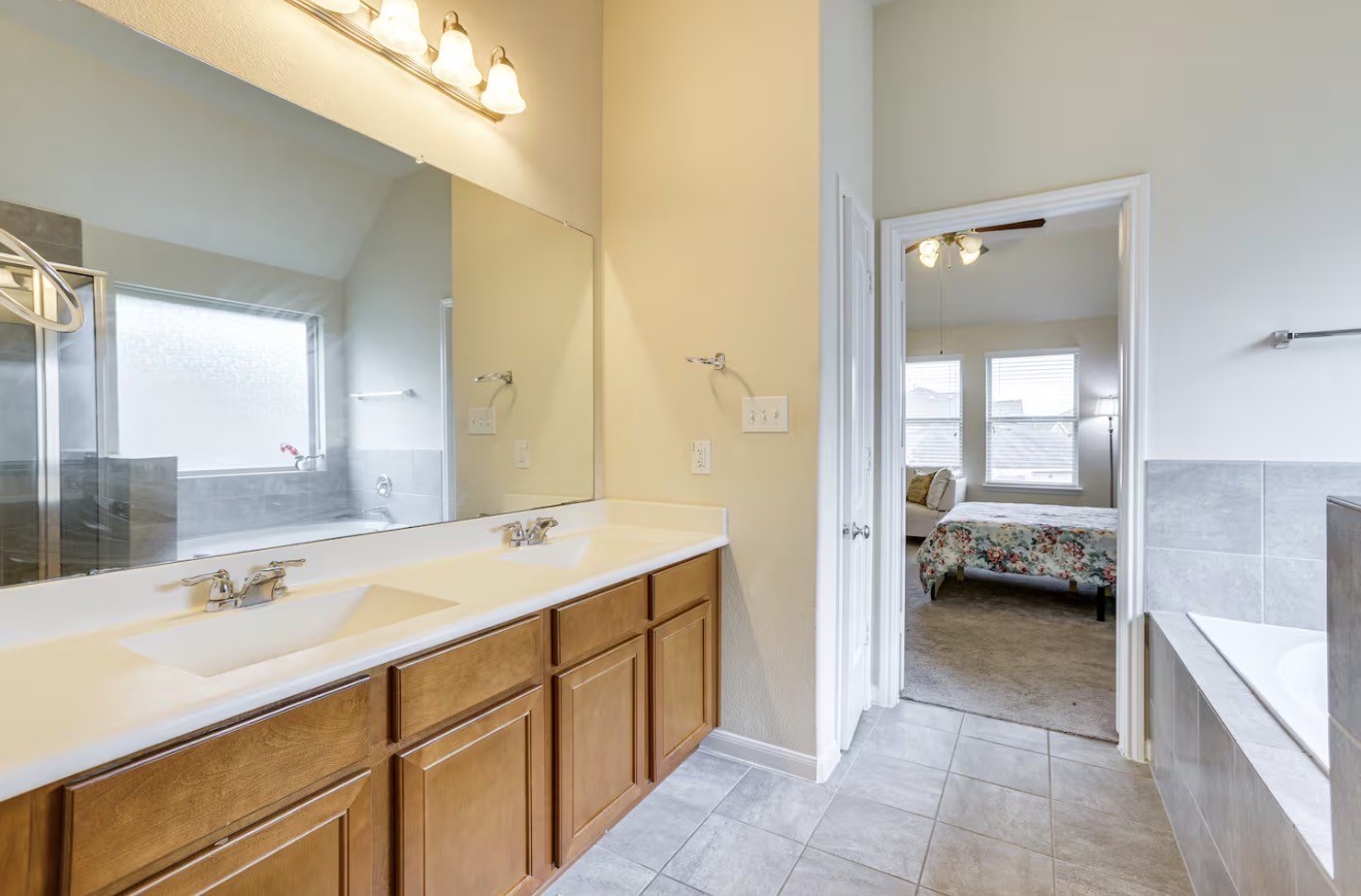 15015 Winter Valley Court Humble, TX 77396 - Photo 21 of 39 a en suite bathroom with a double vanity sink and mirror