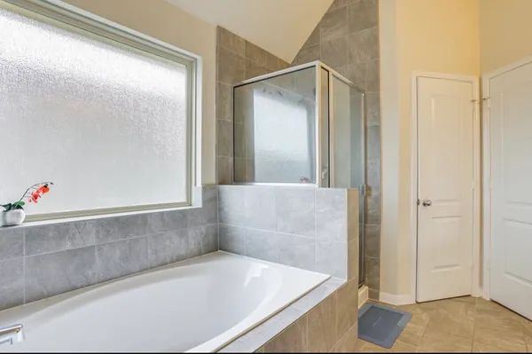 a bathroom with a tub and shower