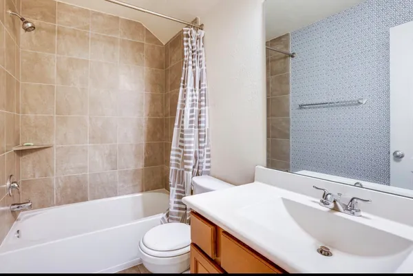 a bathroom with a sink a toilet and a bathtub
