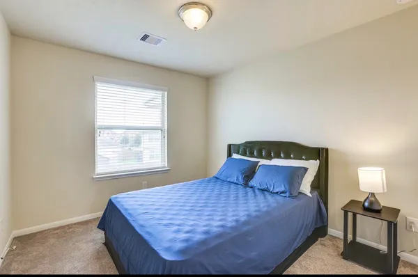 a bedroom with a bed and window