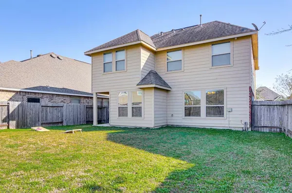 a view of a house with a yard and sitting area