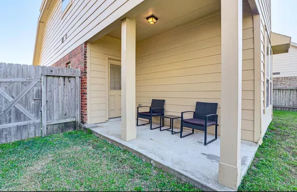 a view of a house with backyard and sitting area