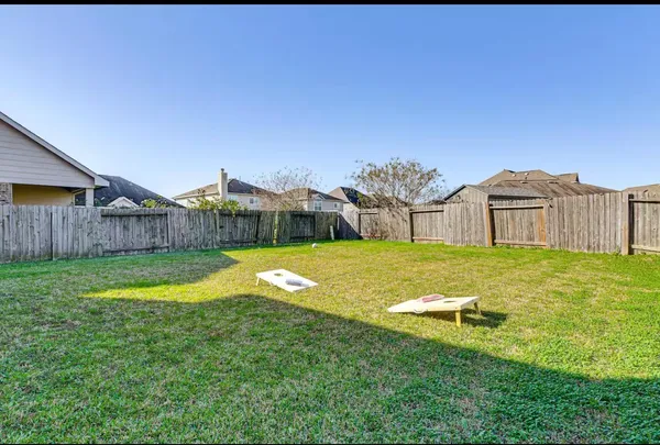 a swimming pool with outdoor seating and yard