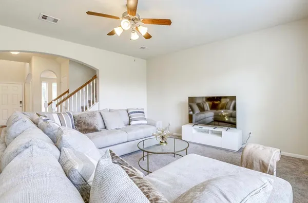 a living room with furniture and a flat screen tv