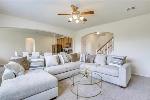 a living room with furniture and a chandelier