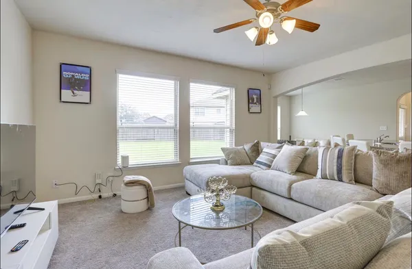 a living room with furniture and a large window