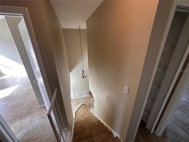 an empty room with closet and entryway
