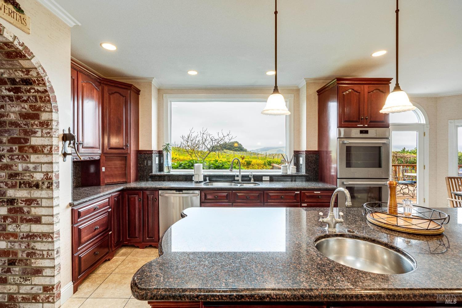 4720 Guenza Road Santa Rosa, CA 95404 - Photo 12 of 94 a kitchen with kitchen island granite countertop a sink and a stove
