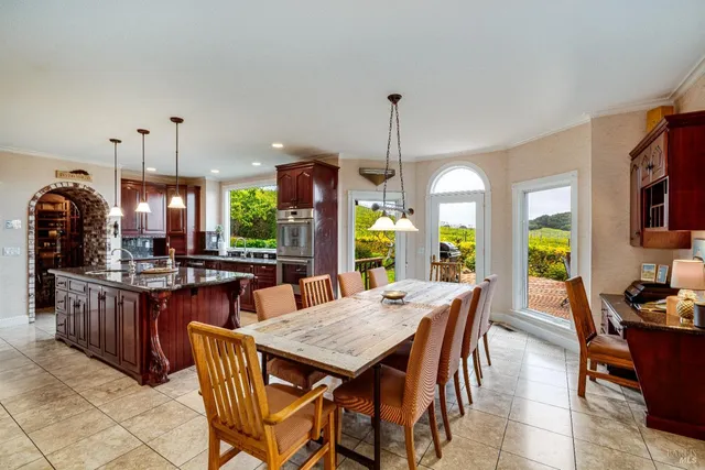 a bedroom with a bed and a large mirror next to a window