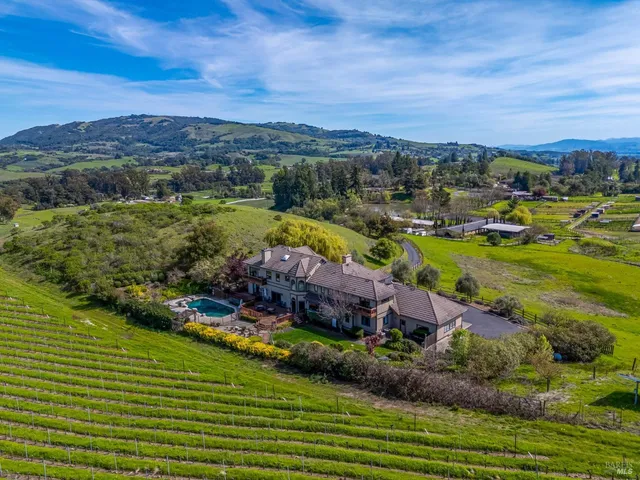 a kitchen with stainless steel appliances granite countertop sink stove and wooden cabinets