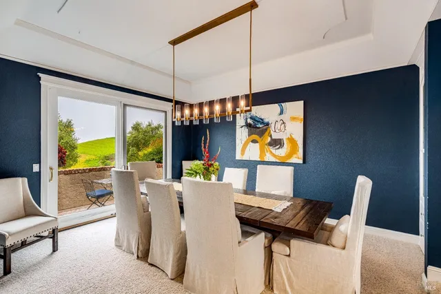 a front view of a house with a yard and potted plants