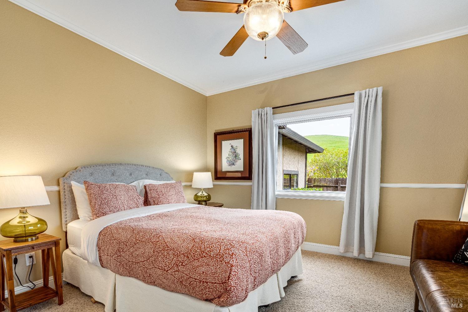 4720 Guenza Road Santa Rosa, CA 95404 - Photo 41 of 94 a bedroom with a bed and a chandelier