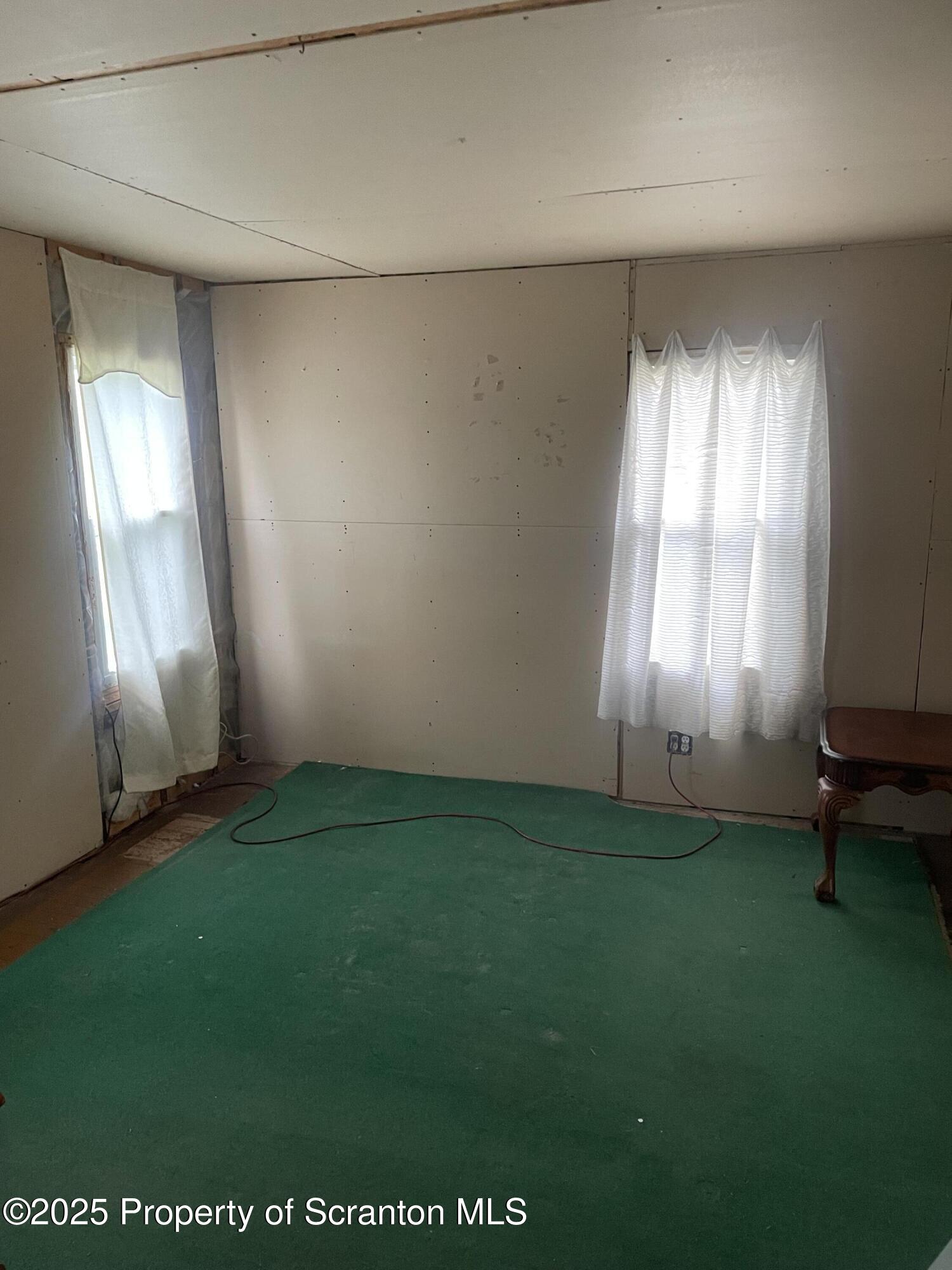 841 Hill Street Archbald, PA 18403 - Photo 13 of 22 an empty room with windows and yard