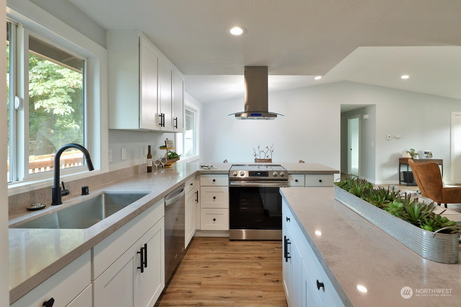 21704 4th Avenue West Bothell, WA 98021 - Photo 11 of 23 a large kitchen with stainless steel appliances a sink a stove and a wooden floors