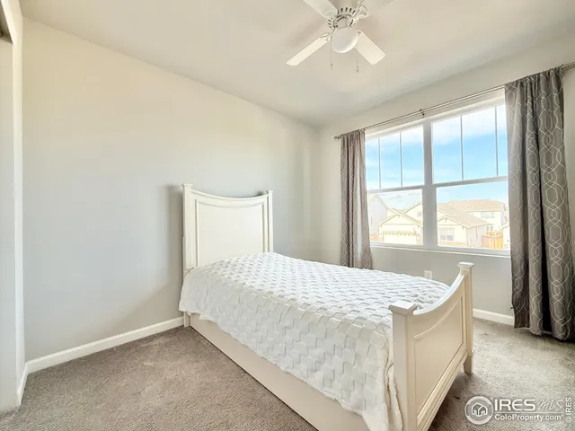 a bed sitting in a bedroom next to a window