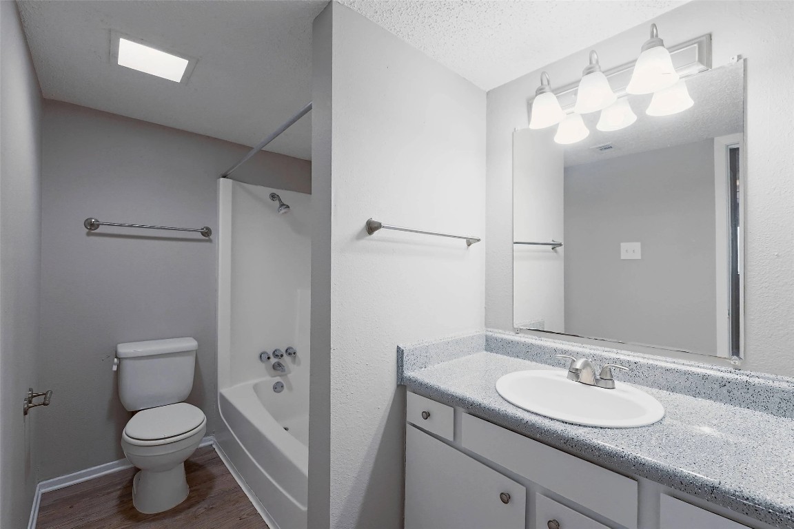 8100 North Mopac Expressway, Unit 1204 Austin, TX 78759 - Photo 18 of 24 Full bathroom with shower / washtub combination, vanity, a textured ceiling, and wood finished floors