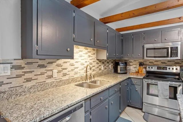 a kitchen with sink cabinets and microwave