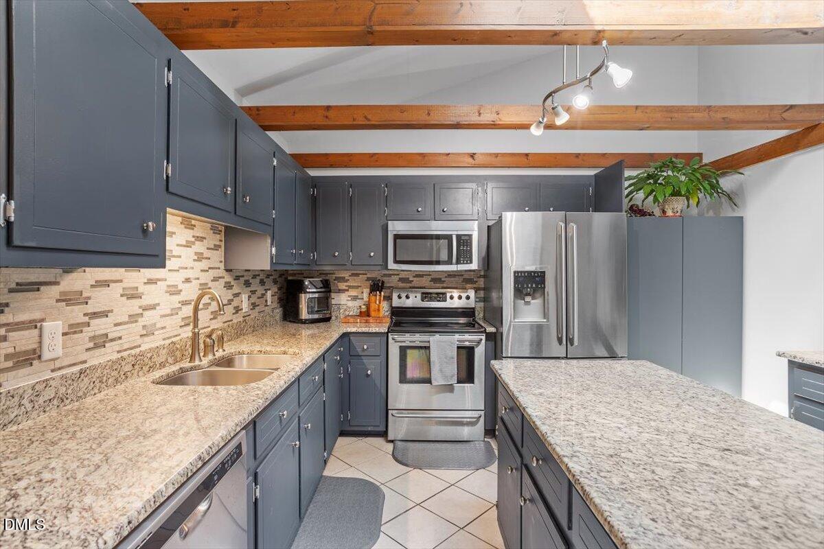 9966 US Highway 421 South Erwin, NC 28339 - Photo 16 of 34 a kitchen with stainless steel appliances granite countertop a sink stove microwave and refrigerator