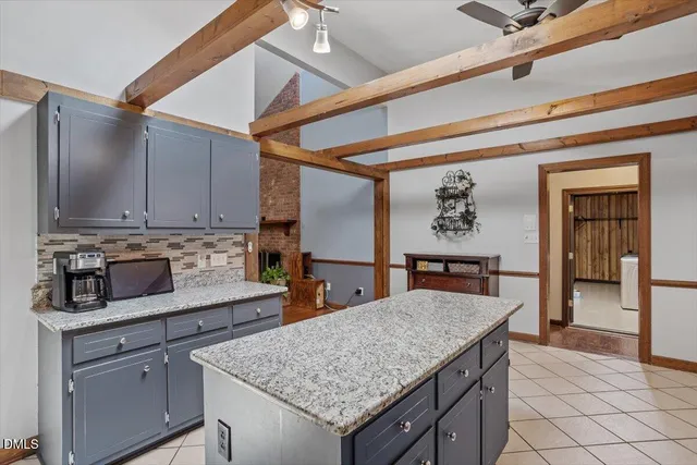 a kitchen with stainless steel appliances granite countertop a sink dishwasher and cabinets with wooden floor