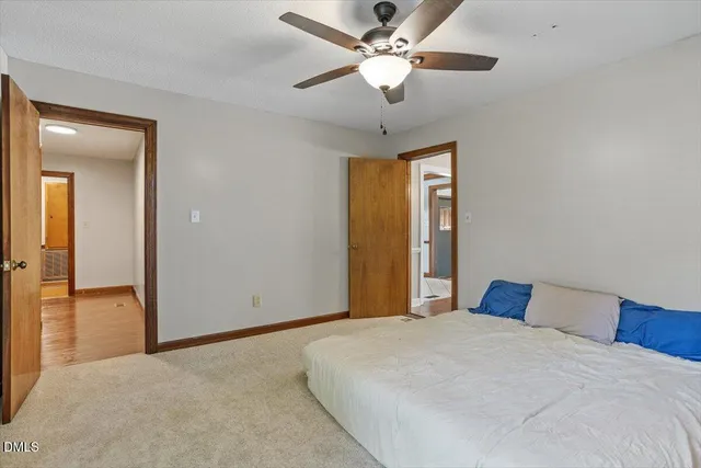 a bedroom with a large bed and a chandelier