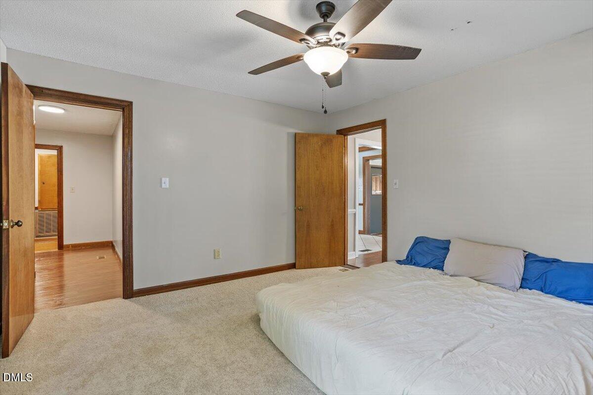 9966 US Highway 421 South Erwin, NC 28339 - Photo 23 of 34 a bedroom with a large bed and a chandelier
