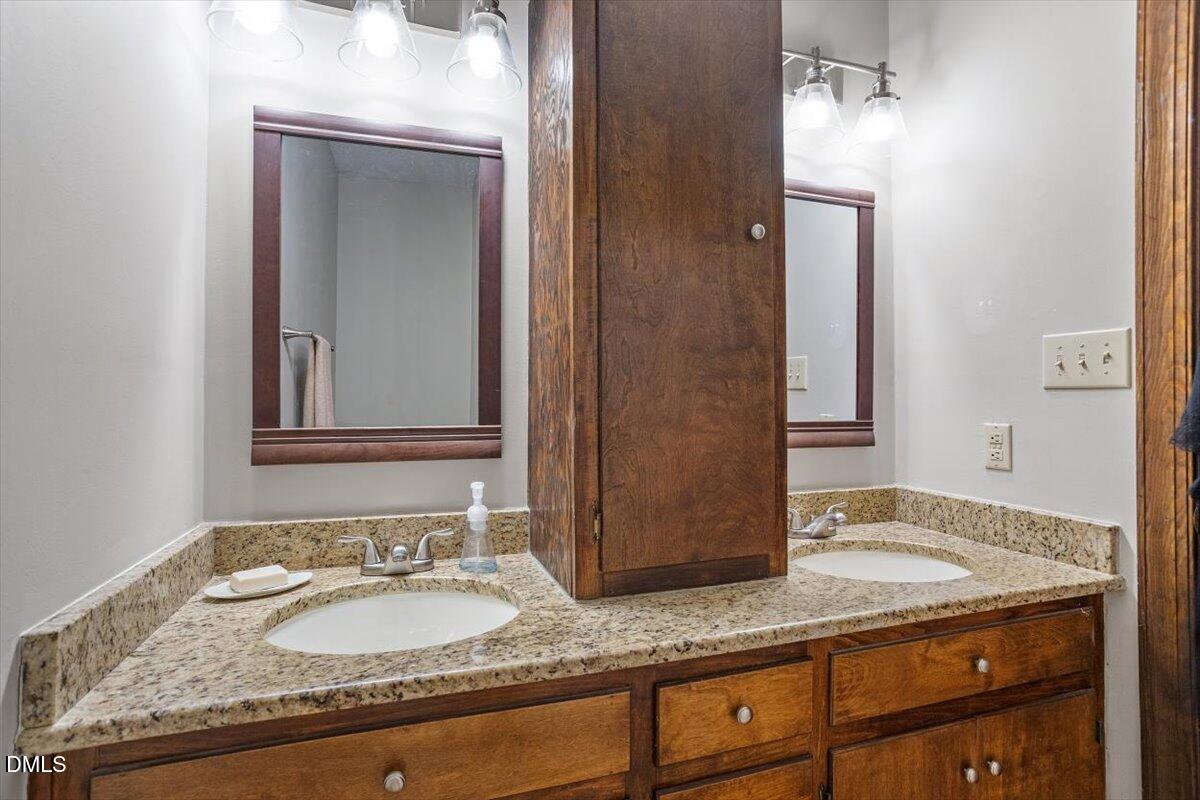 9966 US Highway 421 South Erwin, NC 28339 - Photo 24 of 34 a bathroom with a granite countertop sink and a mirror
