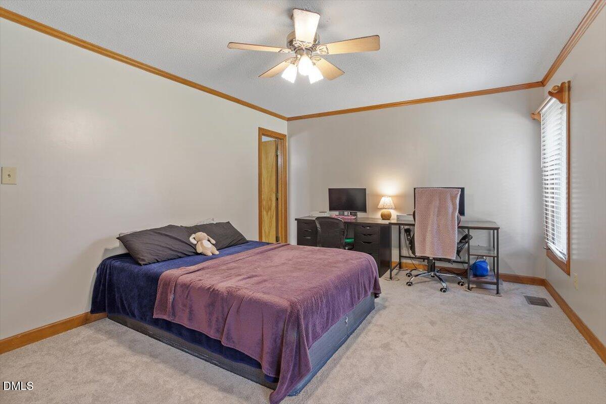 9966 US Highway 421 South Erwin, NC 28339 - Photo 26 of 34 a bedroom with a bed desk and a window