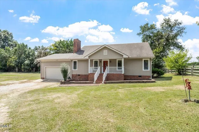 a view of a house with a yard and swimming pool