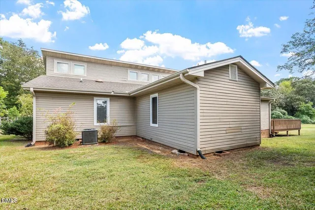 a view of a backyard with plants and a barbeque