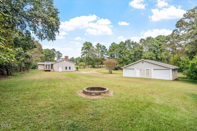 a view of a house with a yard and trees