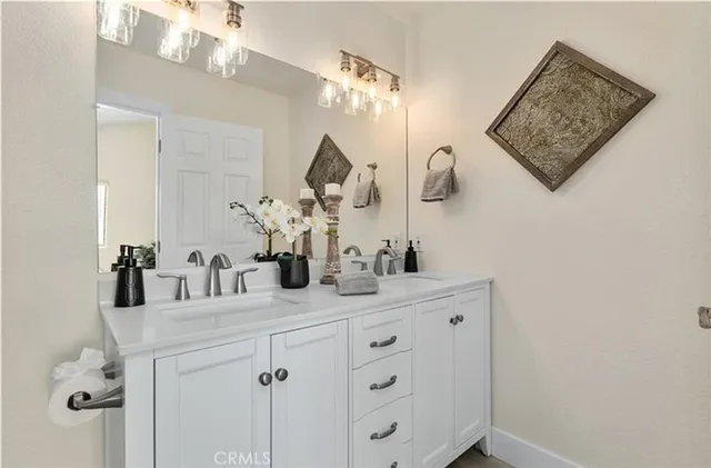 a bathroom with a double vanity sink and a mirror