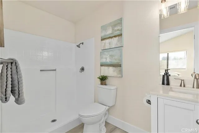 a bathroom with a shower a toilet and a sink