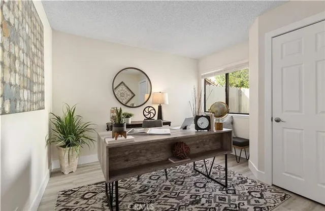 a view of a workspace room with furniture and mirror