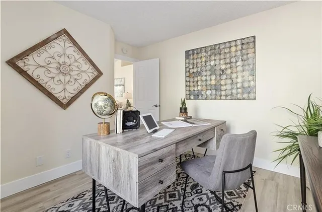 a view of a workspace with furniture and window