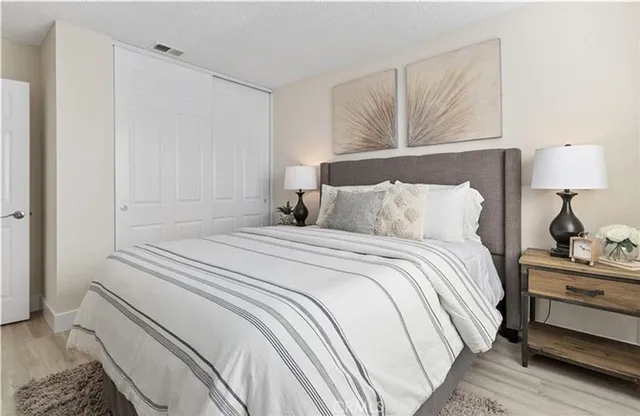 a bedroom with a bed and a night stand