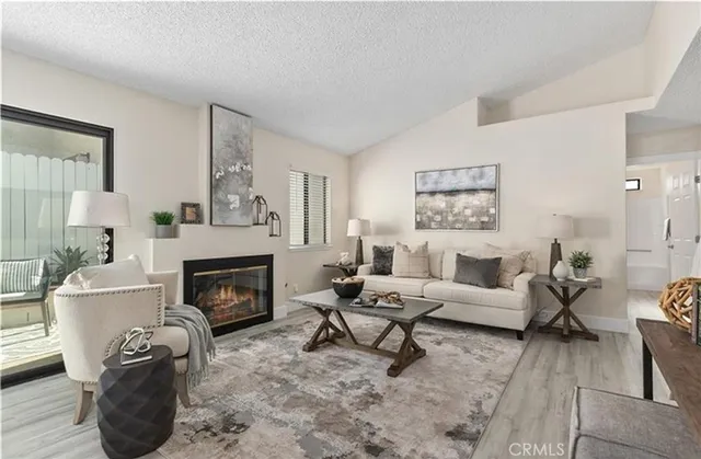 a living room with furniture and a fireplace