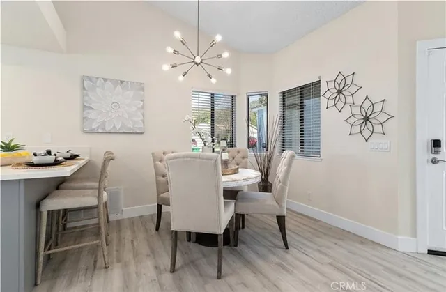 a dining room with furniture a window and wooden floor