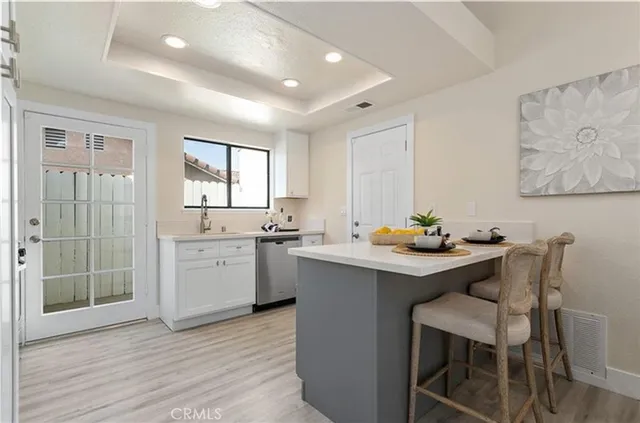 a kitchen with a sink cabinets and wooden floor