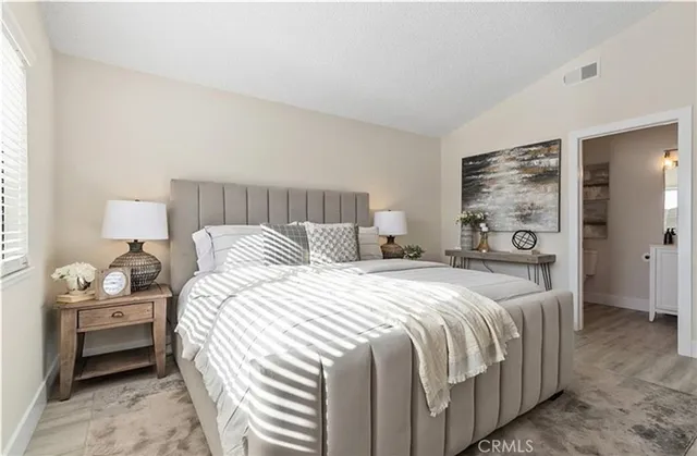 a bedroom with a bed and a night stand