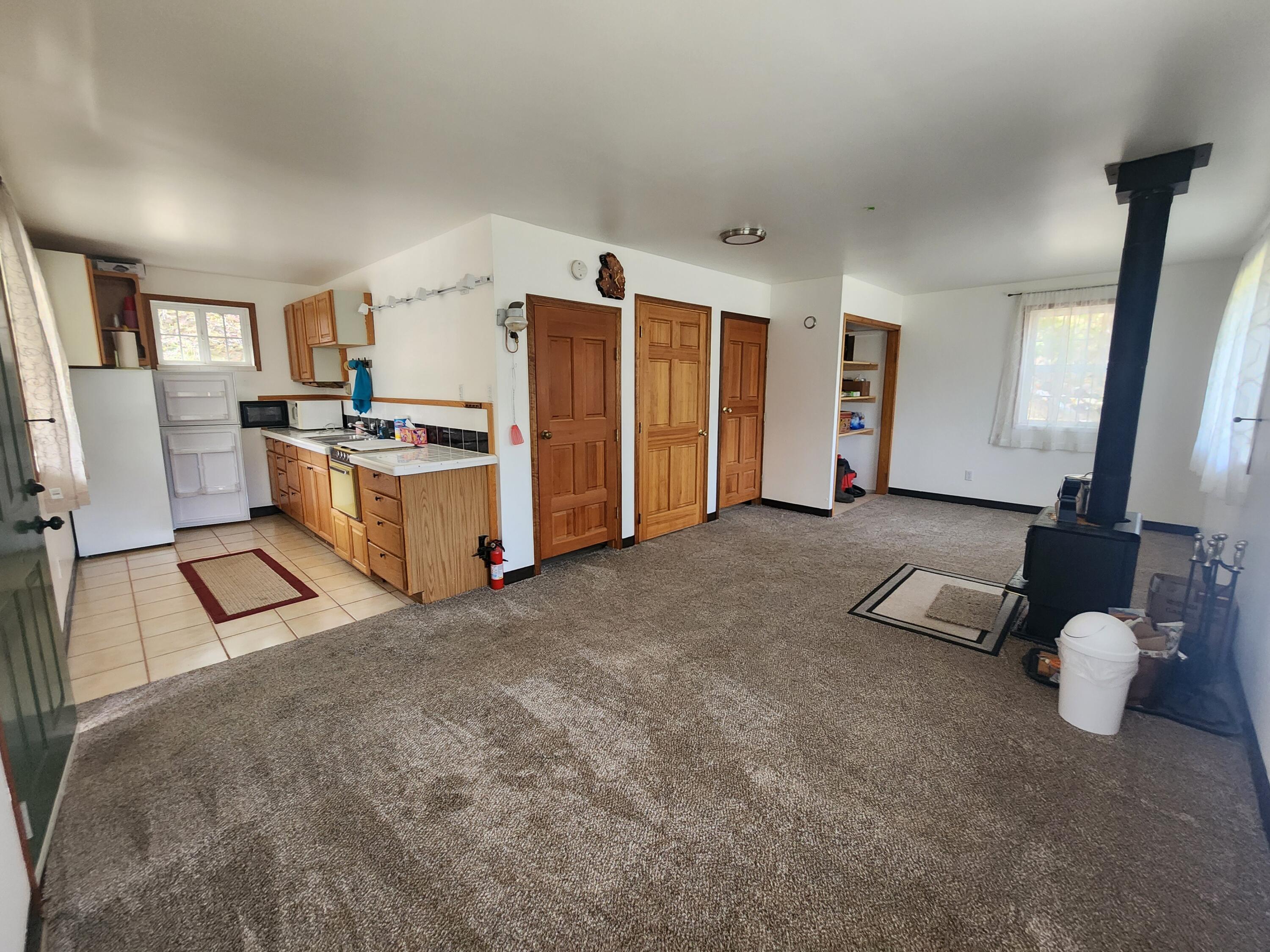 11238 East Evans Creek Road Rogue River, OR 97537 - Photo 3 of 29 a living room with furniture and a flat screen tv