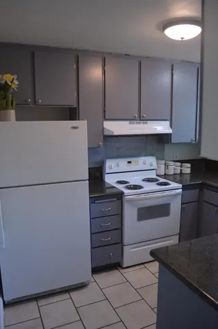 a kitchen with a stove cabinets and refrigerator