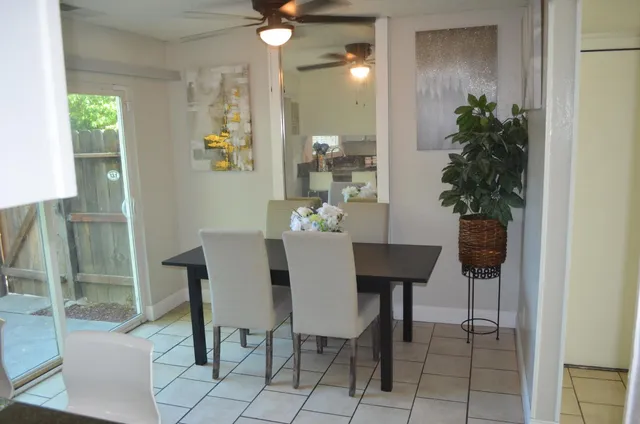 a view of a dining room with furniture and a potted plant