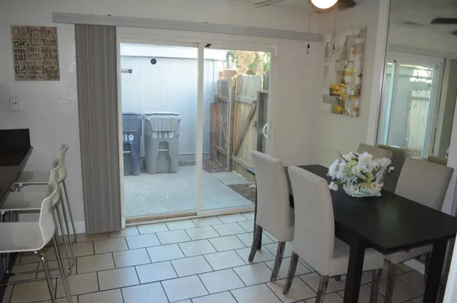a view of a dining room with furniture and a potted plant