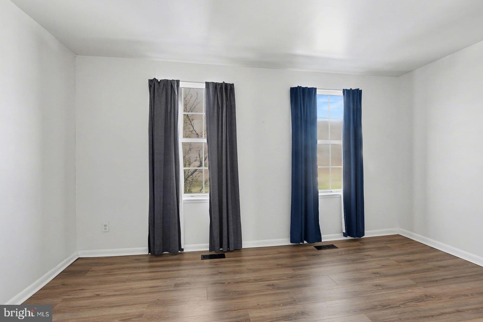 834 West Spring Meadow Court Edgewood, MD 21040 - Photo 10 of 25 an empty room with wooden floor and windows