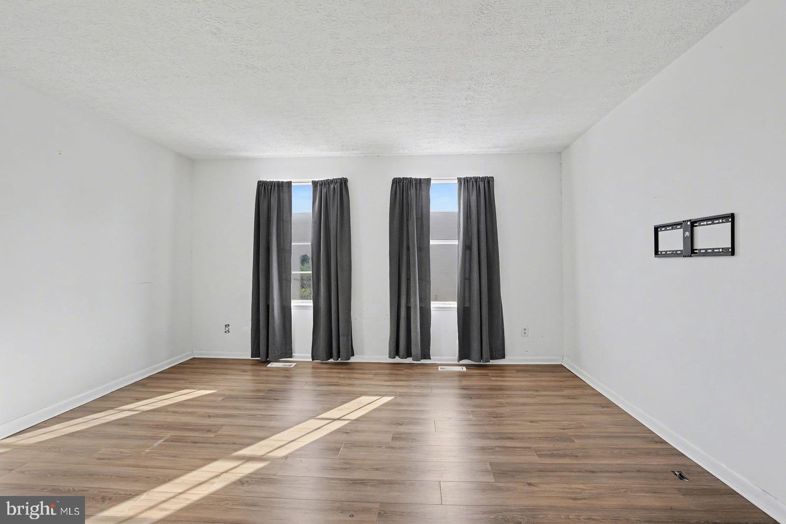 834 West Spring Meadow Court Edgewood, MD 21040 - Photo 13 of 25 an empty room with wooden floor and windows